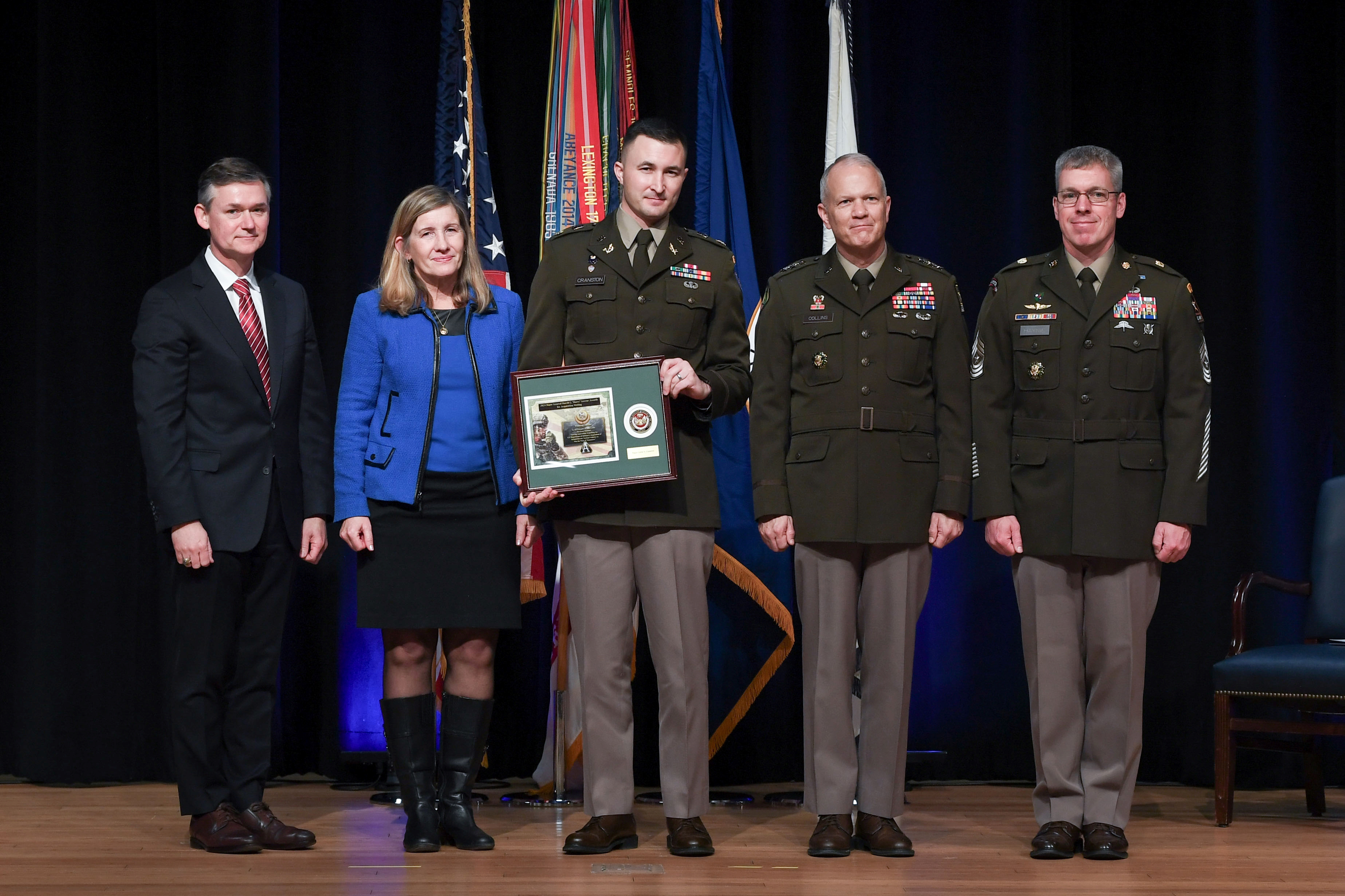 MAJ Curtis Cranston (center) received the Major General Harold
            “Harry” J. Greene Acquisition Writing Award in the category
            of Innovation for his essay, Driving Innovation: Propelling the U.S.
            Department of Defense’s Acquisition of Hybrid-Electric Tactical Vehicles
            to Win the Wars of Tomorrow. Also pictured from left to right: Hon.
            Douglas R. Bush (ASA (ALT)); COL(R) Sue Myers (spouse of MG
            “Harry” Greene); LTG Robert Collins (Principal Military Deputy,
            ASA (ALT)); and CSM Robert Haynie (ASA (ALT) Sergeant
            Major). (Photo courtesy of MAJ Curtis Cranston)
